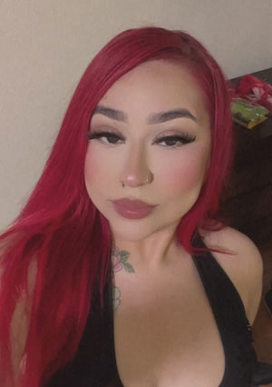 The image is a photograph of team member Gaby, a Front Desk Receptionist