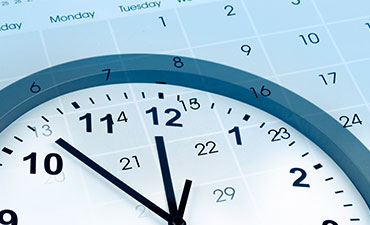 A digital clock with a blue background set to 9 05, superimposed on a calendar grid.